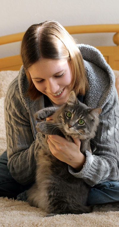 Girl w/ cat on bed